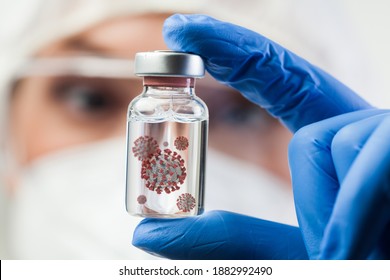 Female UK lab scientist doctor holding glass ampoule dish containing Coronavirus molecule cell,new IHU virus strain,COVID-19 RNA mutation change,conceptual visualization,cure research illustration  - Shutterstock ID 1882992490