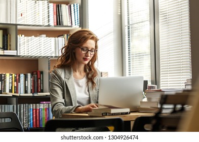 Female University Professor Preparing For Class.She Using Laptop	.