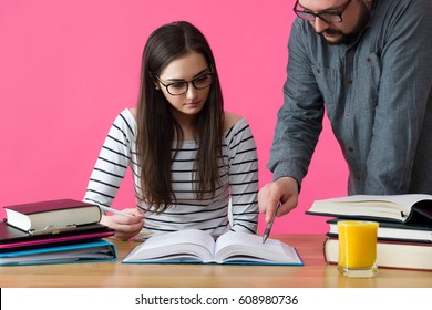 Female university student working one to one with tutor. Tutor helping student to prepare for exams