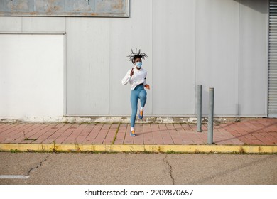 Female Urban Athlete On Hiit Training Doing Running In Place Exercise. Cardio Workout Outside During Coronavirus Pandemic. Sporty Woman Exercising With Face Mask.