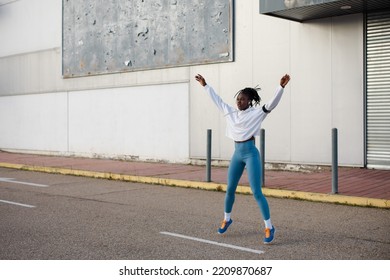 Female urban athlete on Hiit training doing explosive running technique exercise. Cardio training outside. - Shutterstock ID 2209870687