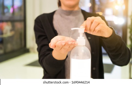 Female Using Alcohol Gel As Hand Sanitizer At Shopping Center For Prevent The Spread Of Germs And Bacteria And Avoid Infections Corona Virus. Hygiene Concept