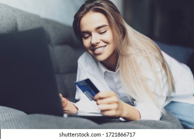 Female Using Bank Card To Pay For Goods Purchased Online. Safe Payment Services For Customers Of Worldwide Retailers.