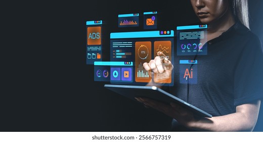 Female using futuristic touchscreen with glowing UI elements and graphs, dark background, concept of software, data, technology, innovation
