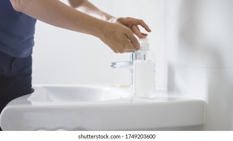 Female using hand sanitizer gel pump dispenser for bacteria and virus disinfection. - Shutterstock ID 1749203600