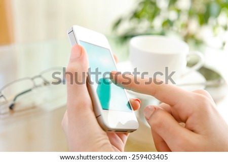Female using her mobile phone.