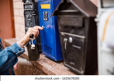 Female Is Using Key For Unlocking Letterbox And Checking New Mail. Website Banner