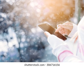 Female using mobile smartphone outdoor, nature background - Powered by Shutterstock