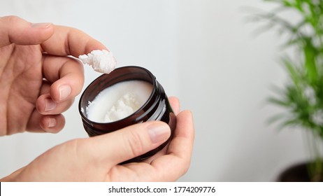 Female using pure shea butter cream. Natural anti-aging cosmetics treatment concept.