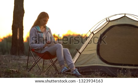 Female using tablet for navigation in woods, 3g internet coverage to rural area