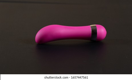 Female vibrator. Stimulating sex toy. Surface lubrication. Lubricant for sex. Pink vibrating massager for women.