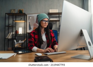 Female Video Editor Works Indoors In Creative Office Studio.