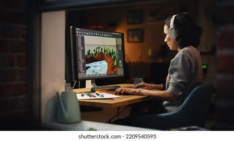 Female Video Game Designer Works on a New 3D Level on Personal Computer. Focused Woman Creating Metaverse and Design Video Game. Shot Into the Apartment Window Late at Night. - Shutterstock ID 2209540593