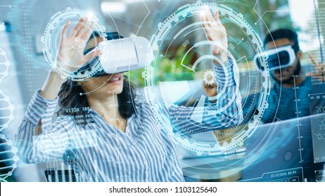Female Virtual Reality Engineer/ Developer Wearing Virtual Reality Headset Creates Content With Her Colleagues. Bright Young People Work with Holograms in Augmented & Mixed Reality Project.