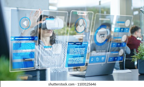 Female Virtual Reality Engineer/ Developer Wearing Virtual Reality Headset Creates Content With Her Colleagues. Bright Young People Work with Holograms in Augmented & Mixed Reality Project.
