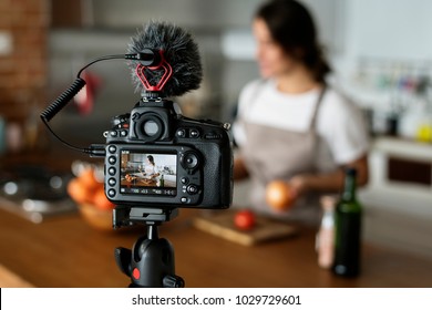 Female vlogger recording cooking related broadcast at home - Powered by Shutterstock