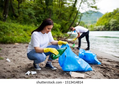 Female Volunteer Collecting Garbage Outside