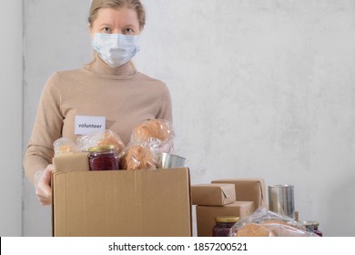 Female Volunteer Working In Food Bank Warehouse. Woman Is Sorting Food. Helping Poor And Needy People. Donation Concept.