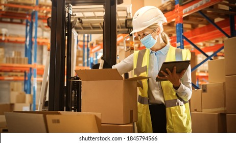 Female Warehouse Inventory Manager Wearing Face Mask For Safety, Using Digital Tablet Computer, Checking Cardboard Boxes. Delivery Distribution Center With Goods, Products Ready For Shipment