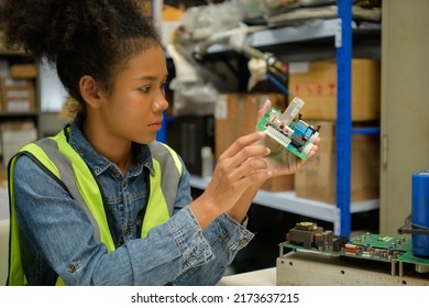 Female Warehouse Worker Counting Items In An Industrial Warehouse On The Factory's Mezzanine Floor. Which Is A Storage For Small And Light Electronic Parts.