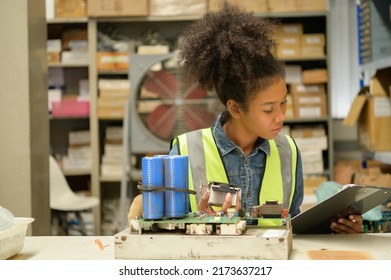 Female Warehouse Worker Counting Items In An Industrial Warehouse On The Factory's Mezzanine Floor. Which Is A Storage For Small And Light Electronic Parts.