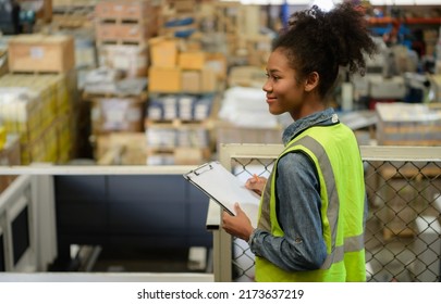 Female Warehouse Worker Counting Items In An Industrial Warehouse On The Factory's Mezzanine Floor. Which Is A Storage For Small And Light Electronic Parts.