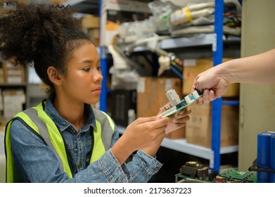 Female Warehouse Worker Counting Items In An Industrial Warehouse On The Factory's Mezzanine Floor. Which Is A Storage For Small And Light Electronic Parts.