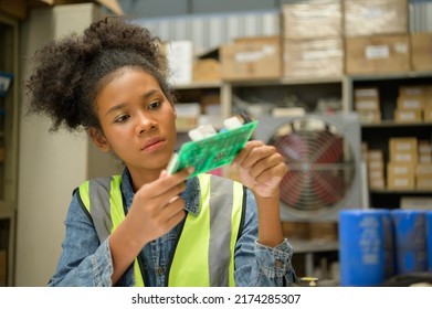 Female Warehouse Worker Counting Items In An Industrial Warehouse On The Factory's Mezzanine Floor. Which Is A Storage For Small And Light Electronic Parts.