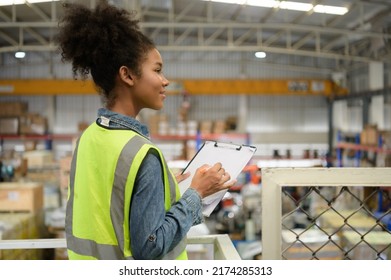 Female Warehouse Worker Counting Items In An Industrial Warehouse On The Factory's Mezzanine Floor. Which Is A Storage For Small And Light Electronic Parts.