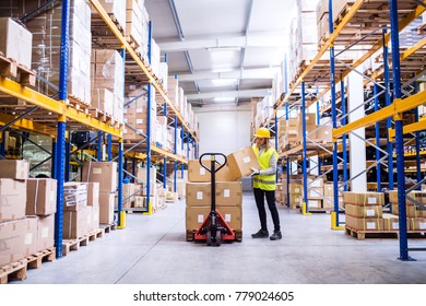 Female warehouse worker loading or unloading boxes.