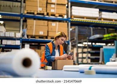 Female Warehouse Worker Using Mobile Phone