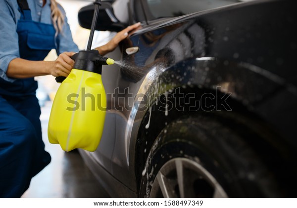 Female washer\
with wax spray, car wash\
service