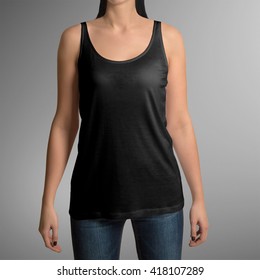 Female wearing black tank top shirt, isolated on gray background, with clipping path to change background