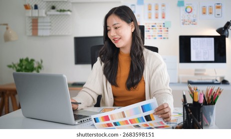 Female web designer developing mobile app layout, reviewing user interface mockups and design plans.