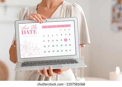 Female wedding planner with laptop in office, closeup