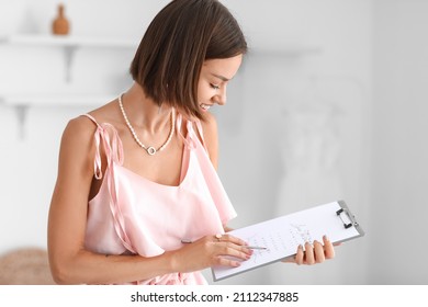 Female wedding planner working in office - Shutterstock ID 2112347885