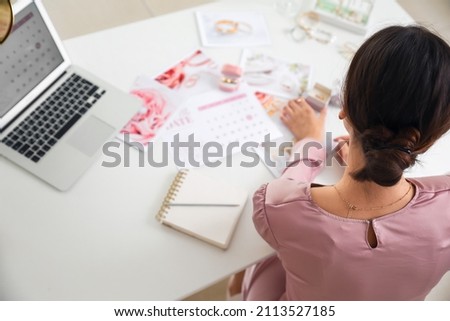 Female wedding planner working in office