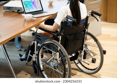 Female wheelchair user who works at company. Scenery of the meeting. - Powered by Shutterstock