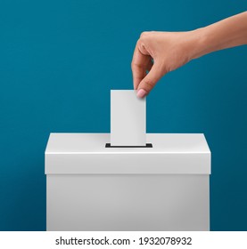 female or women Voter Holds Envelope In her  Hand Above Vote Ballot for casting vote on blue background