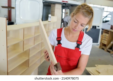 A Female Woodworker Measuring Chipboard