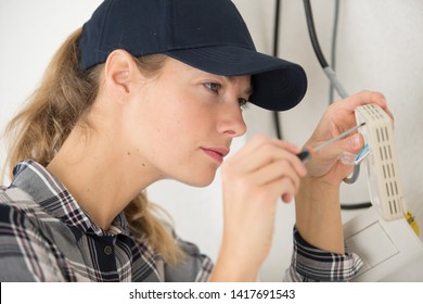 Female Worker Dealing With A Broken Thermostat