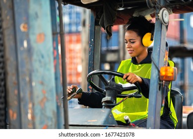Female worker driving forklift in industrial container warehouse. - Powered by Shutterstock