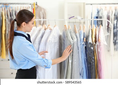 Female worker in dry-cleaning salon