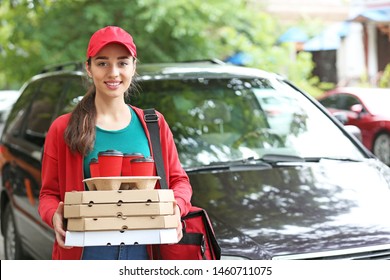 Female Worker Of Food Delivery Service Near Car Outdoors