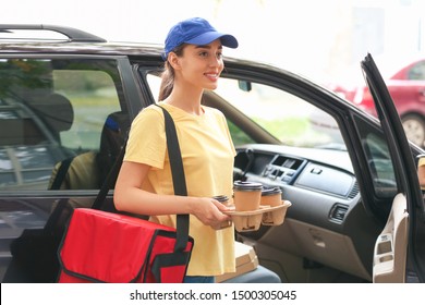 Female Worker Of Food Delivery Service Near Car Outdoors