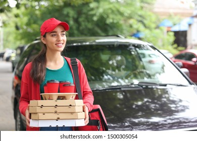 Female Worker Of Food Delivery Service Near Car Outdoors