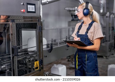 Female Worker Hold Inspection Control, In Protective Workwear Working In Medical Supplies Research And Production Factory And Checking Bottles Of Pesticides Before Shipment.