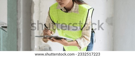 Female worker occupation. Woman inspector checking interior material process in house reconstruction project.