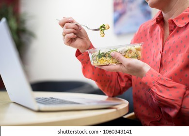 Female Worker In Office Having Healthy Pasta Lunch At Desk