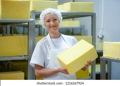 Female Worker On Yellow Cheese Production Line In An Industrial Factory
